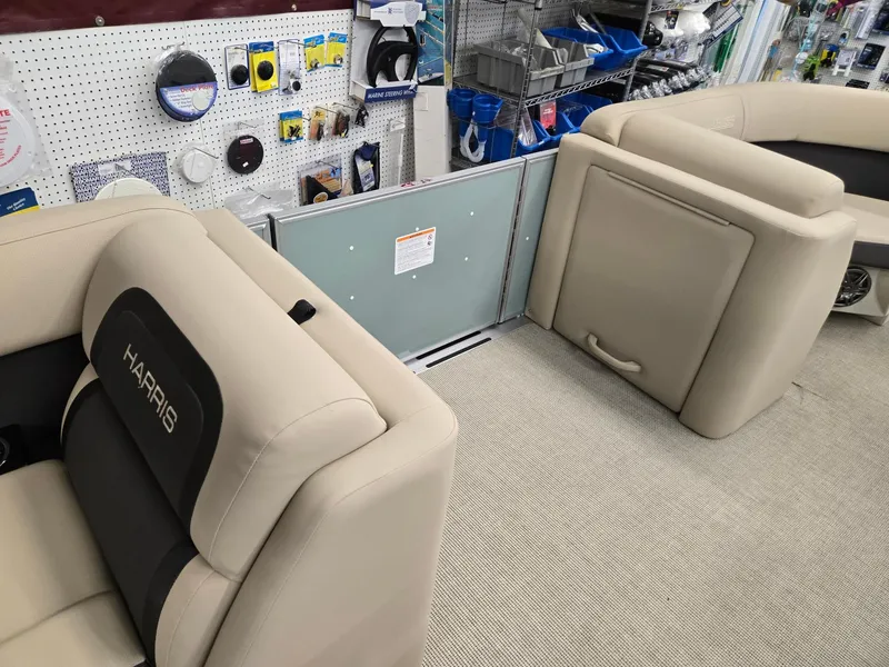 Slide: The Image of 2025 Harris Cruiser 210 boat interior with beige seating and accessories display. - 21