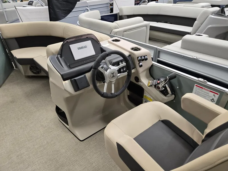 Slide: The Image of 2025 Harris Cruiser 210 boat interior with steering wheel and seating. - 22