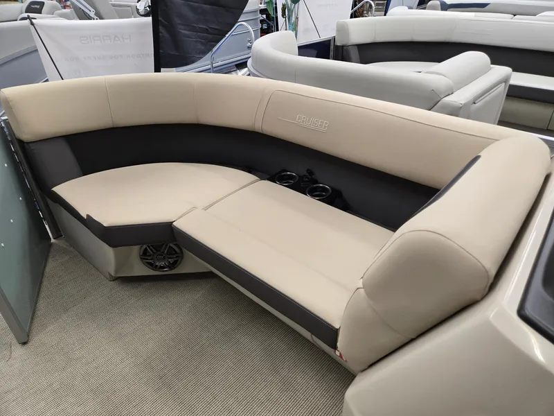 Slide: The Image of 2025 Harris Cruiser 210 boat interior with beige seating and cup holders. - 24