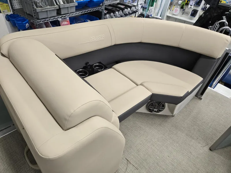 Slide: The Image of Luxurious seating on 2025 Harris Cruiser 210 boat, featuring beige upholstery and integrated cup holders. - 25