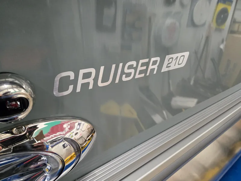 Slide: The Image of 2025 Harris Cruiser 210 boat emblem with chrome detailing. - 26