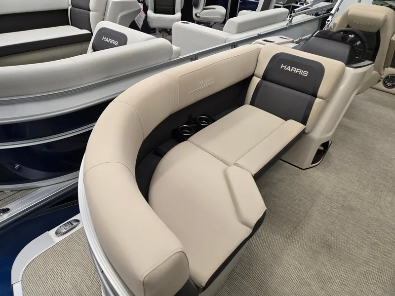 Slide: The Image of 2025 Harris Cruiser 210 boat interior with beige seating and cup holders. - 3