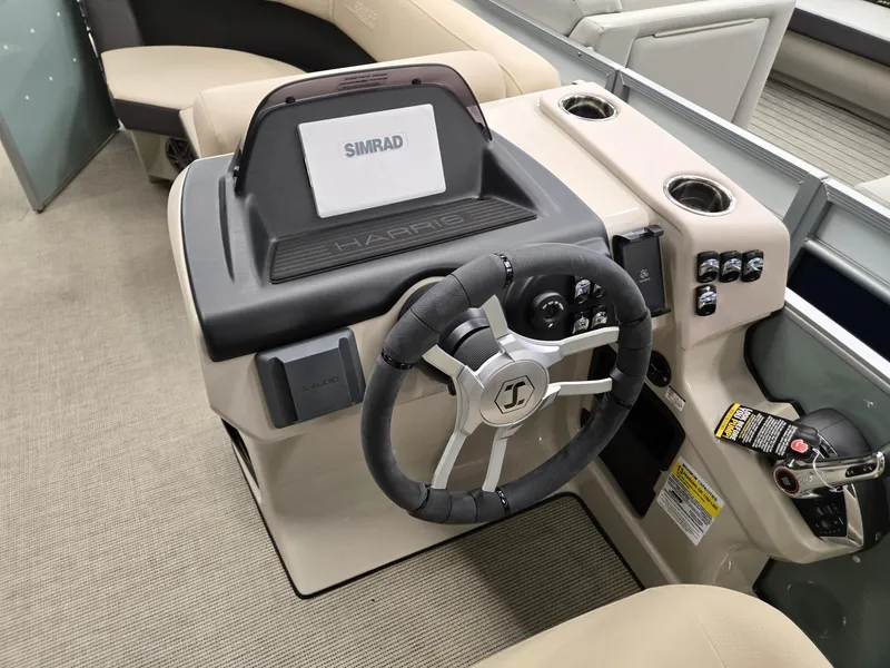 Slide: The Image of 2025 Harris Cruiser 210 boat dashboard with steering wheel and Simrad display. - 7