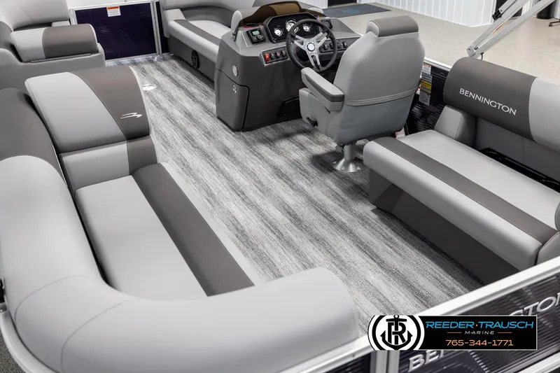 Slide: The Image of 2025 Bennington 21 SSRSE pontoon boat interior with gray seating and modern helm. - 11