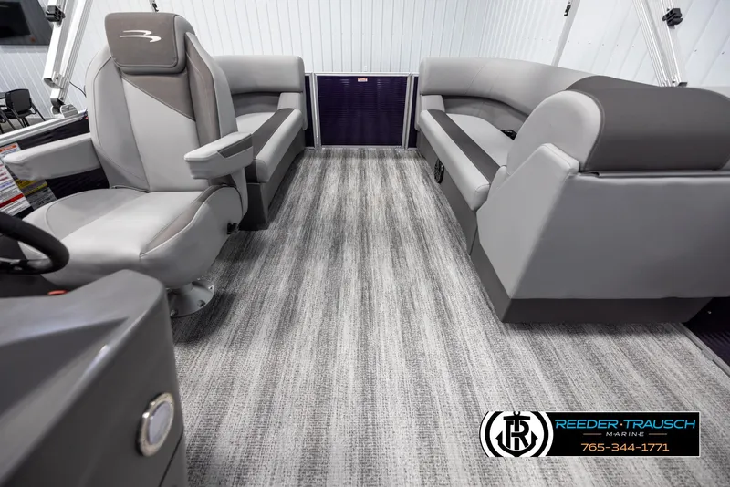 Slide: The Image of 2025 Bennington 21 SSRSE boat interior with gray seating and carpet flooring. - 14