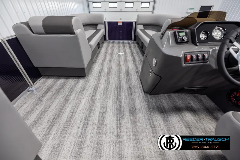 Slide: The Image of Interior of 2025 Bennington 21 SSRSE pontoon boat with modern seating and control panel. - 17