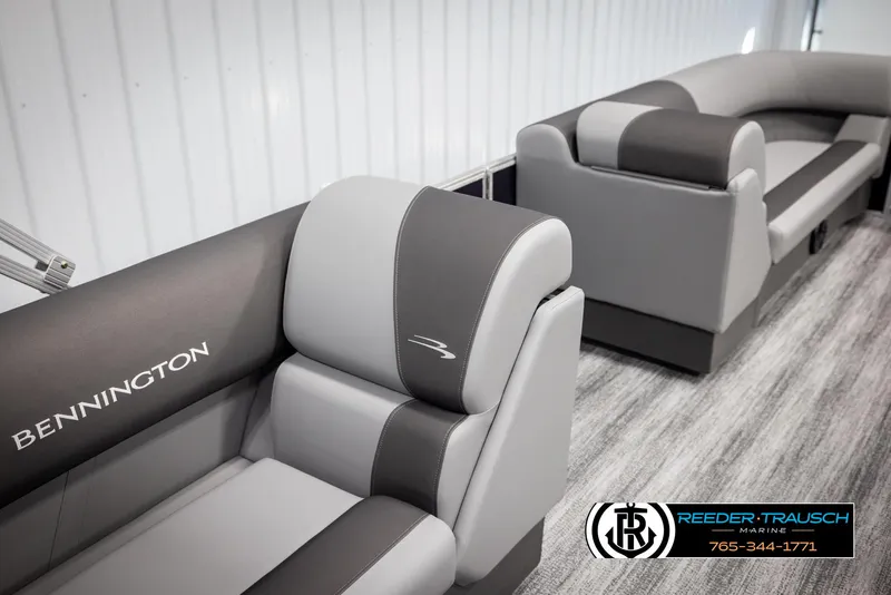 Slide: The Image of 2025 Bennington 21 SSRSE boat interior with gray seating, Reeder-Trausch Marine logo. - 22