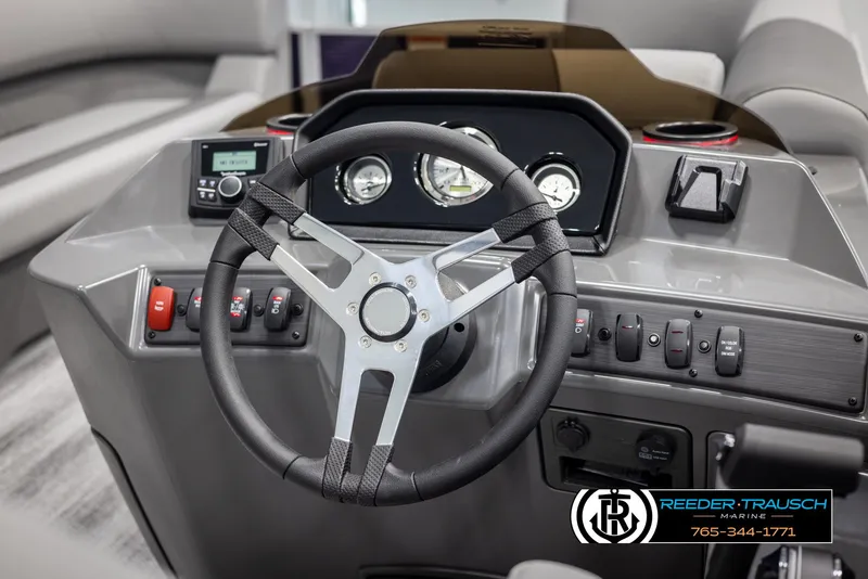 Slide: The Image of 2025 Bennington 21 SSRSE boat dashboard with steering wheel and control panel. - 24