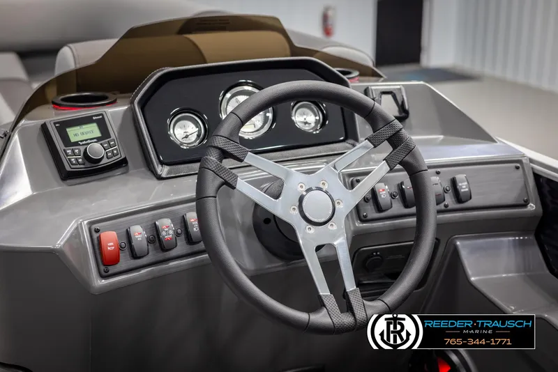 Slide: The Image of 2025 Bennington 21 SSRSE boat dashboard with steering wheel and control panel. - 25