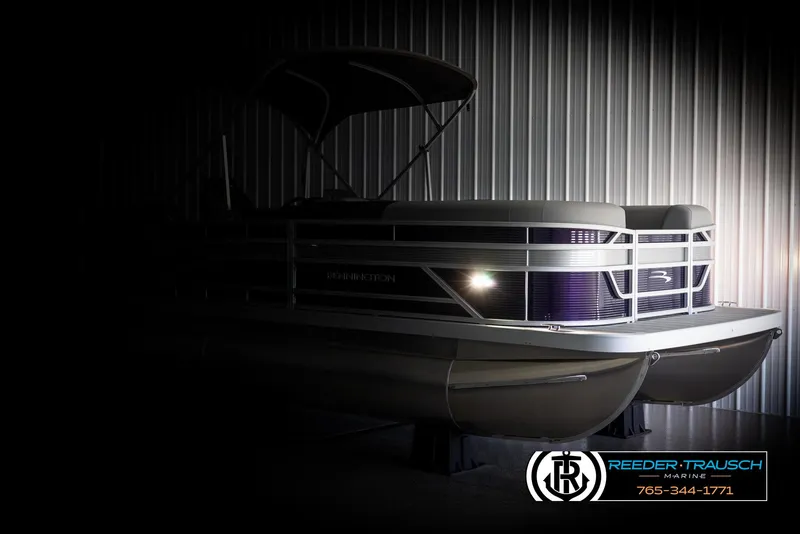 Slide: The Image of 2025 Bennington 21 SSRSE pontoon boat in a dimly lit showroom. - 4