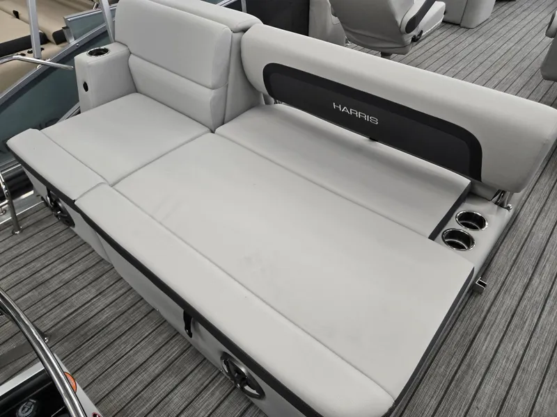 Slide: The Image of 2025 Harris Cruiser 210 boat interior with gray seating and cup holders. - 15