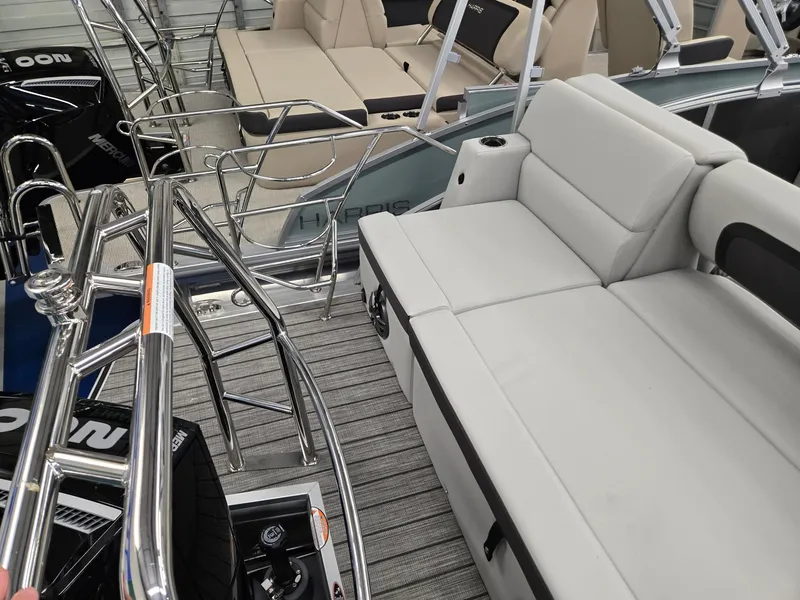 Slide: The Image of 2025 Harris Cruiser 210 boat interior with plush seating and sleek metal railings. - 16