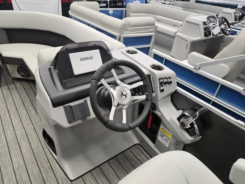 Slide: The Image of 2025 Harris Cruiser 210 boat interior with steering wheel and control panel. - 21