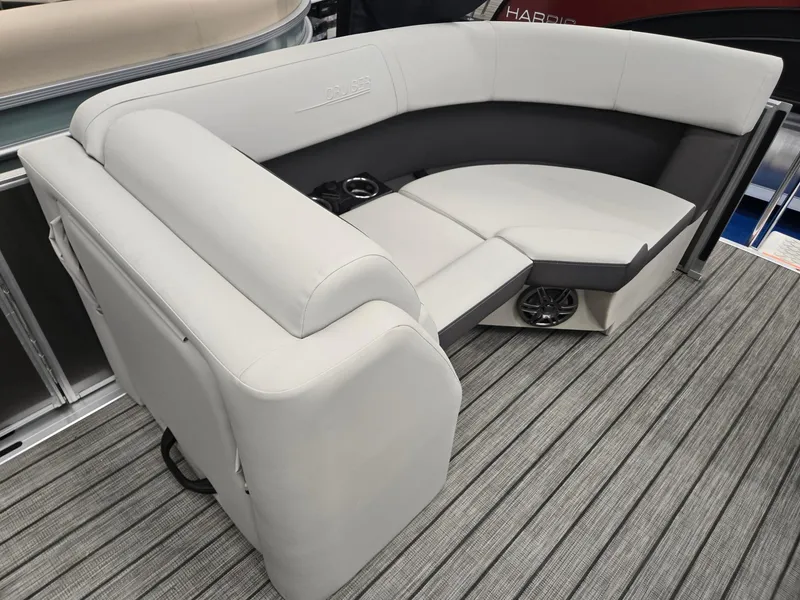 Slide: The Image of 2025 Harris Cruiser 210 boat interior with gray seating and cup holders on a striped deck. - 25