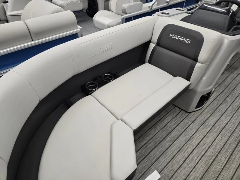 Slide: The Image of 2025 Harris Cruiser 210 boat interior with gray seating and cup holders. - 3