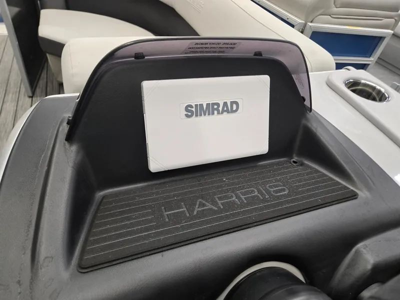 Slide: The Image of 2025 Harris Cruiser 210 dashboard with Simrad navigation system. - 9
