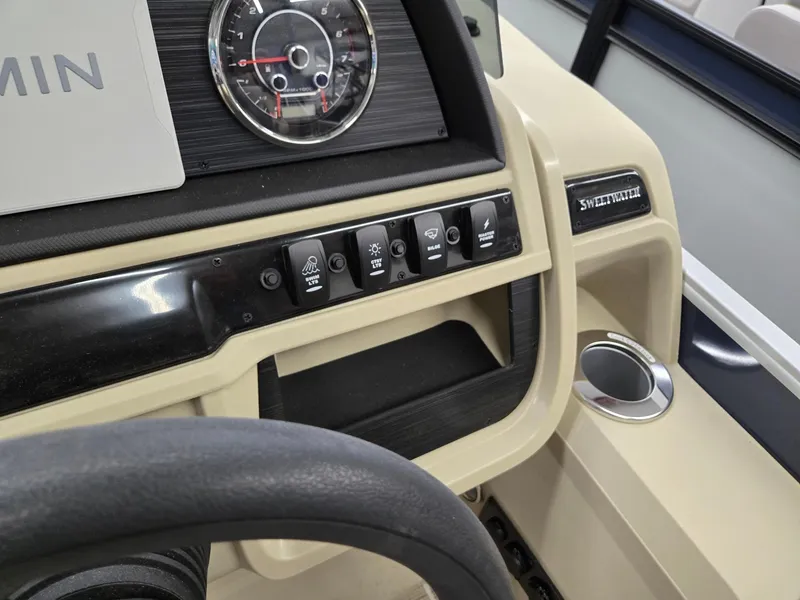 Slide: The Image of Dashboard of 2025 Godfrey SWEETWATER 2286 SB boat with control panel and cup holder. - 10