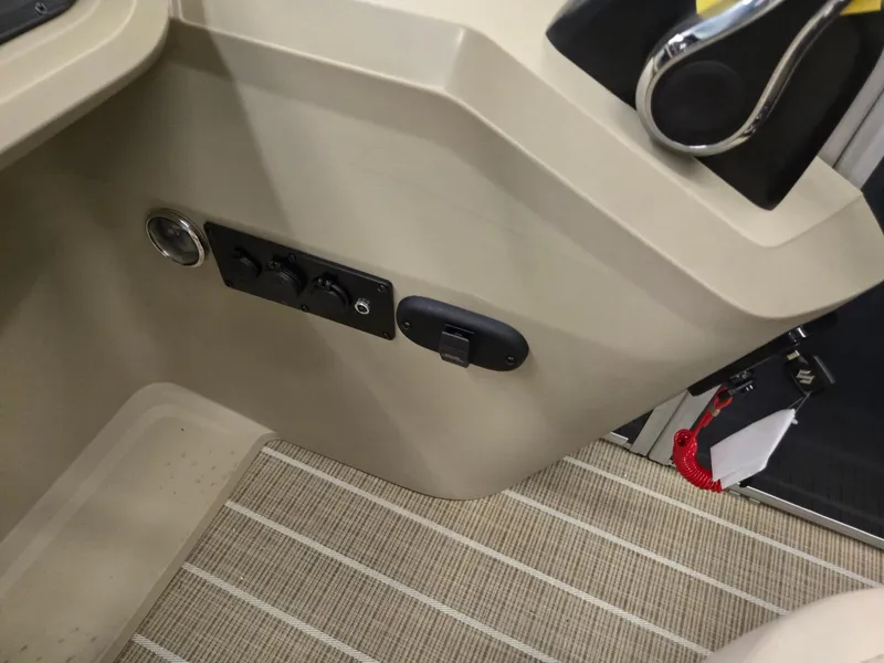 Slide: The Image of Interior controls of 2025 Godfrey SWEETWATER 2286 SB boat, featuring beige panel and striped flooring. - 11
