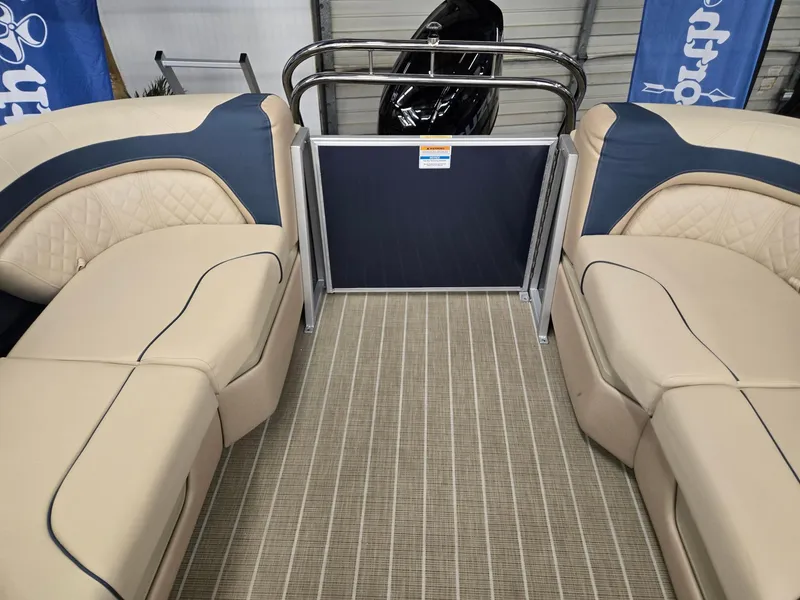Slide: The Image of 2025 Godfrey SWEETWATER 2286 SB boat interior with beige seating and blue accents. - 13
