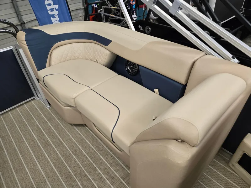 Slide: The Image of 2025 Godfrey SWEETWATER 2286 SB boat interior with beige and blue seating. - 15