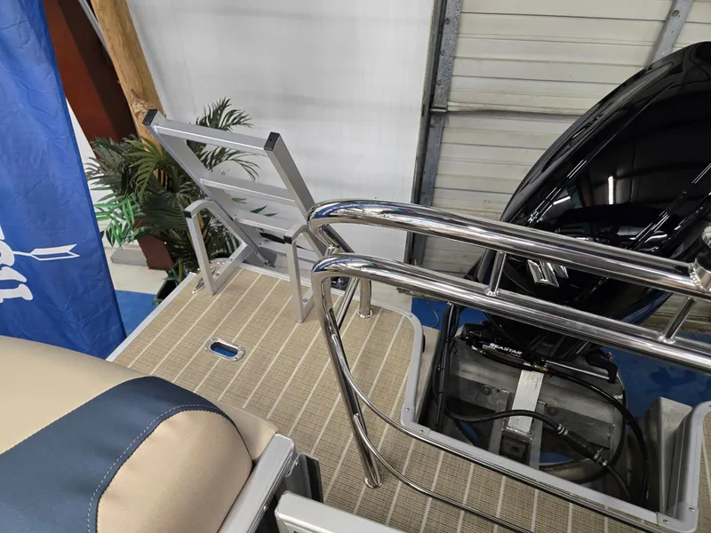 Slide: The Image of 2025 Godfrey SWEETWATER 2286 SB boat deck with railing and motor. - 17