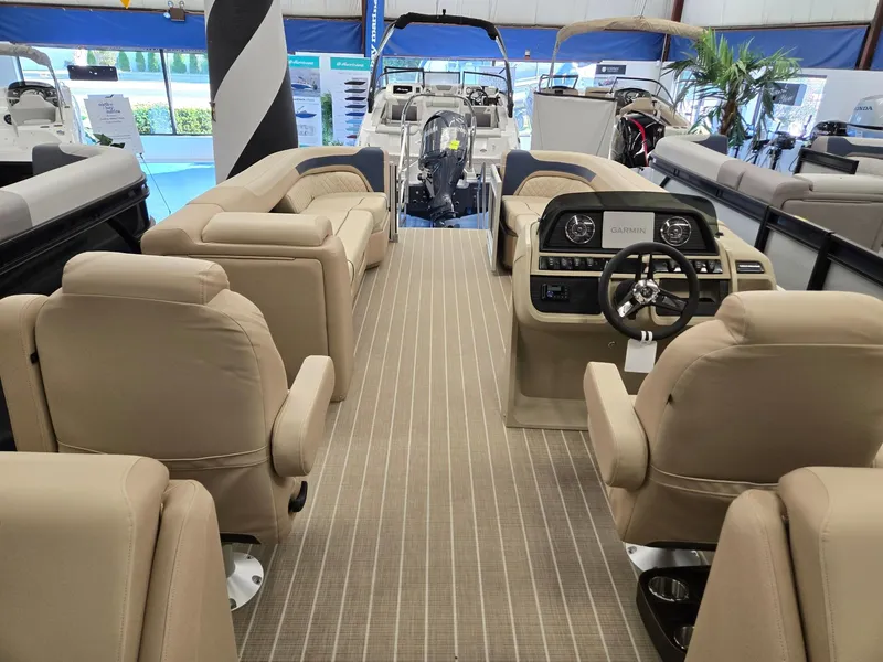 Slide: The Image of 2025 Godfrey SWEETWATER 2286 SB pontoon boat interior with beige seating and modern dashboard. - 19