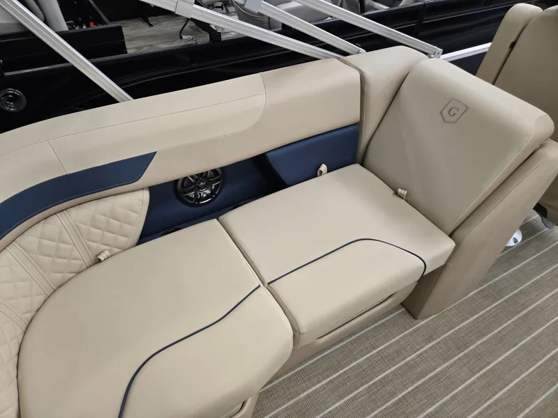 Slide: The Image of 2025 Godfrey SWEETWATER 2286 SB boat interior with beige seating and blue accents. - 20