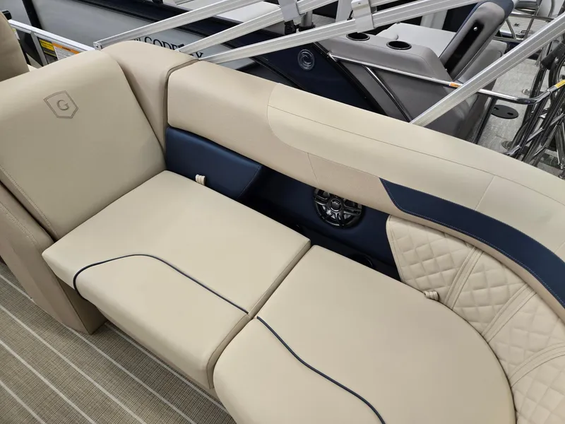 Slide: The Image of 2025 Godfrey SWEETWATER 2286 SB boat interior with beige and navy seating. - 21