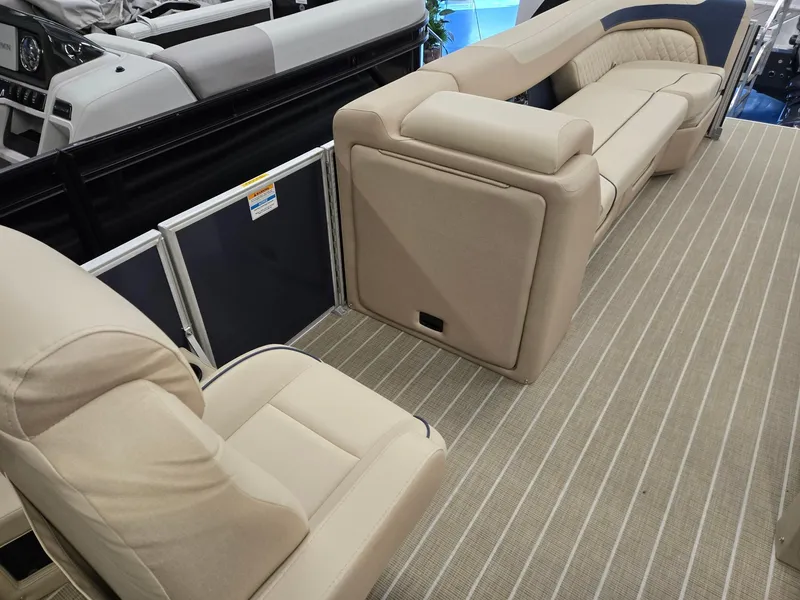 Slide: The Image of 2025 Godfrey SWEETWATER 2286 SB boat interior with beige seating and striped flooring. - 23