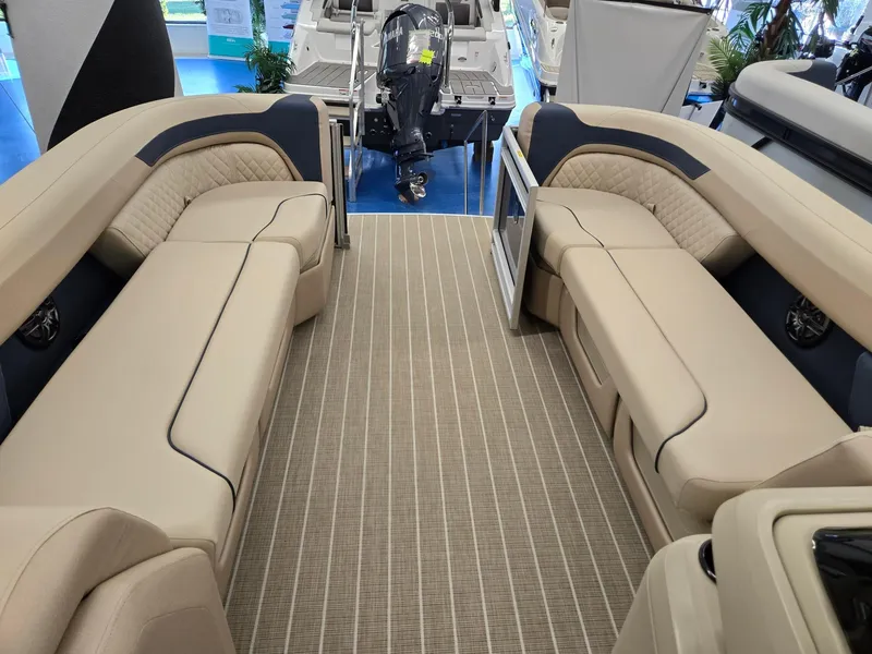 Slide: The Image of 2025 Godfrey SWEETWATER 2286 SB pontoon boat interior with beige seating and striped flooring. - 25