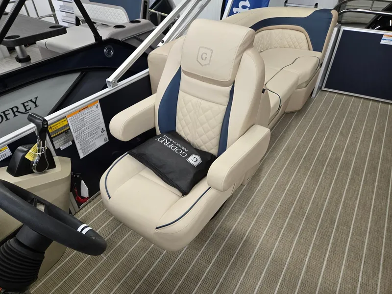 Slide: The Image of 2025 Godfrey SWEETWATER 2286 SB boat interior with luxurious seating and steering wheel. - 6