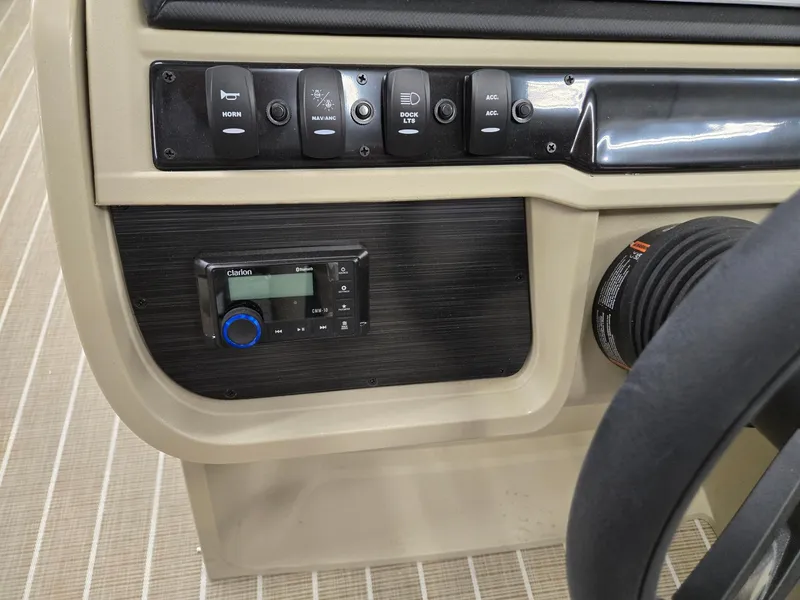 Slide: The Image of Control panel of 2025 Godfrey SWEETWATER 2286 SB boat with switches and audio system. - 9