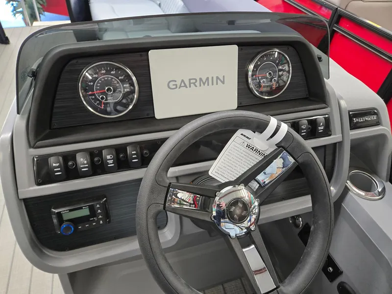 Slide: The Image of 2025 Godfrey SWEETWATER 2286 SFL dashboard with Garmin display and steering wheel. - 10