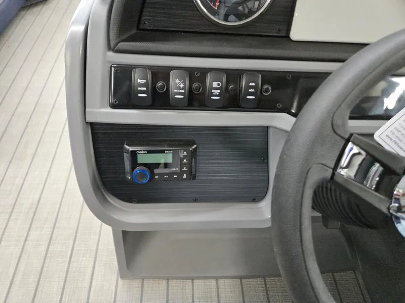 Slide: The Image of Control panel of 2025 Godfrey SWEETWATER 2286 SFL boat with switches and stereo system. - 12