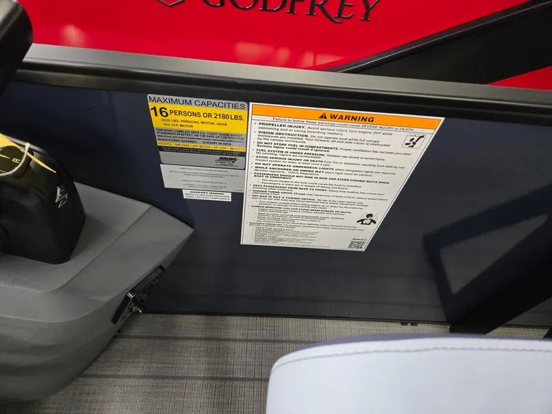 Slide: The Image of 2025 Godfrey SWEETWATER 2286 SFL capacity and warning labels on boat interior. - 14