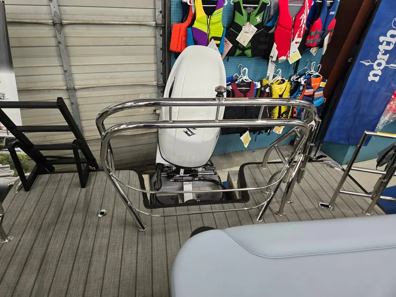 Slide: The Image of 2025 Godfrey SWEETWATER 2286 SFL boat deck with motor and colorful life jackets. - 17