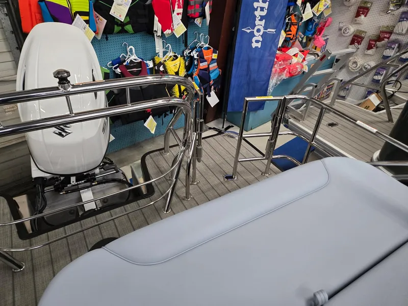 Slide: The Image of 2025 Godfrey SWEETWATER 2286 SFL boat interior with motor and life jackets. - 19