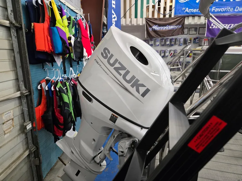 Slide: The Image of Suzuki outboard motor displayed with colorful life jackets, near Godfrey SWEETWATER 2286 SFL, 2025 model. - 32