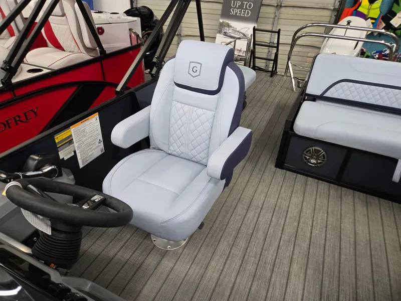 Slide: The Image of 2025 Godfrey SWEETWATER 2286 SFL boat interior with luxury seating and steering wheel. - 8