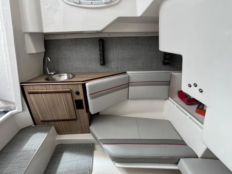 Slide: The Image of 2025 Solara S-250 CW cabin interior with compact kitchenette and seating area. - 19