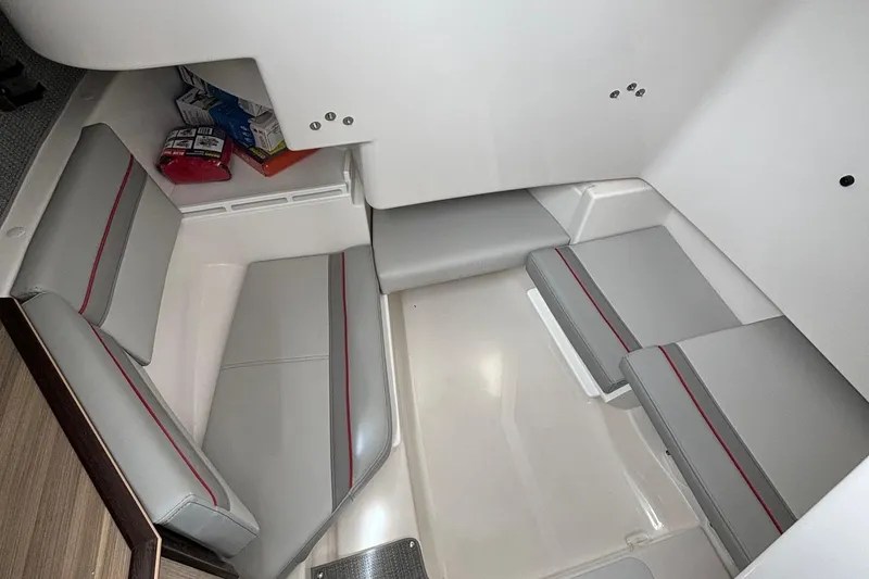 Slide: The Image of 2025 Solara S-250 CW cabin interior with gray seating and storage area. - 21