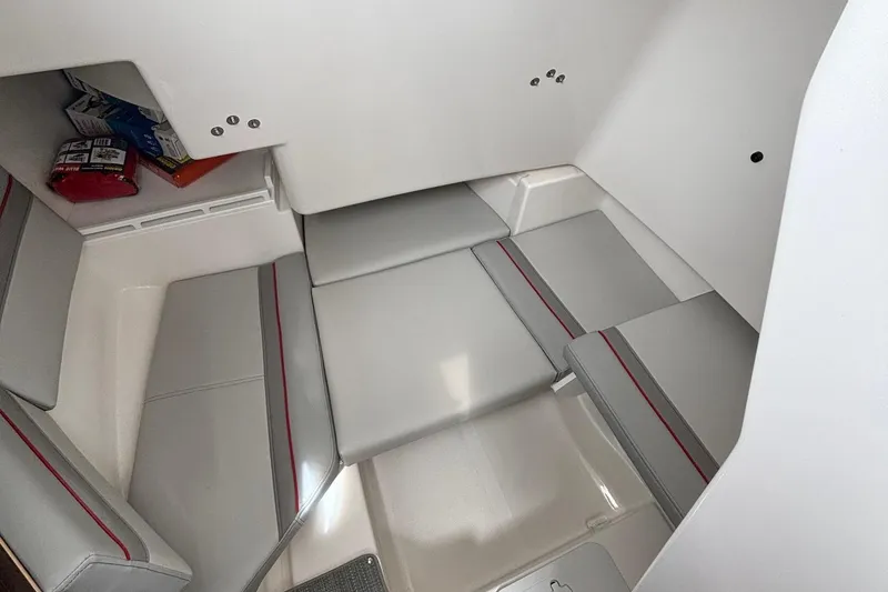 Slide: The Image of 2025 Solara S-250 CW cabin interior with gray seating and red accents. - 22