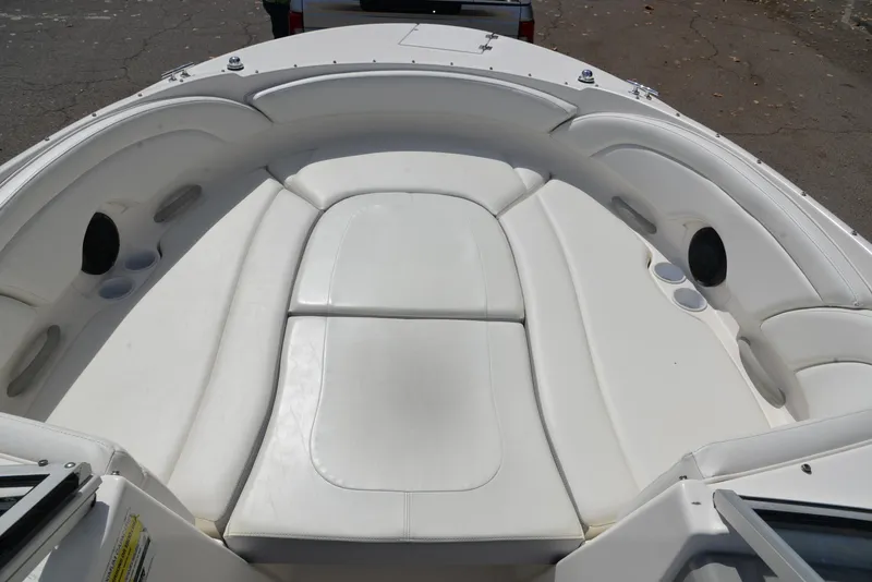 Slide: The Image of 2006 Bayliner 249 SD boat interior with white cushioned seating. - 19