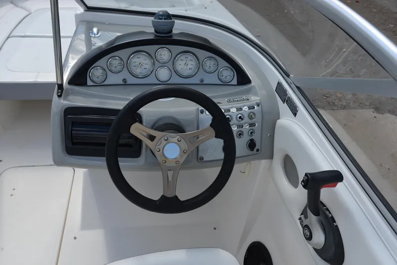 Slide: The Image of 2006 Bayliner 249 SD boat dashboard with steering wheel and control panel. - 22