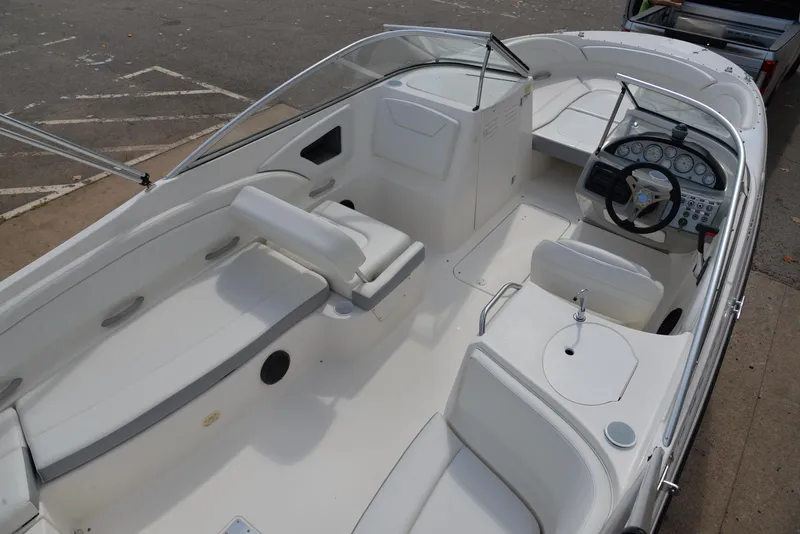 Slide: The Image of 2006 Bayliner 249 SD boat interior with seating and steering console. - 26