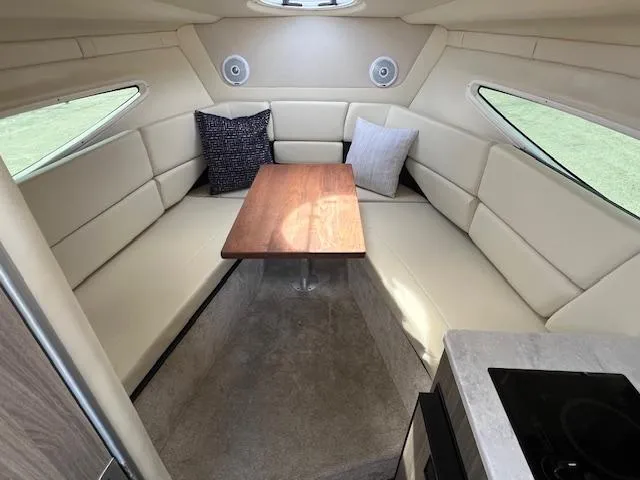Slide: The Image of 2019 Regal 26 Express cabin interior with seating and table. - 12