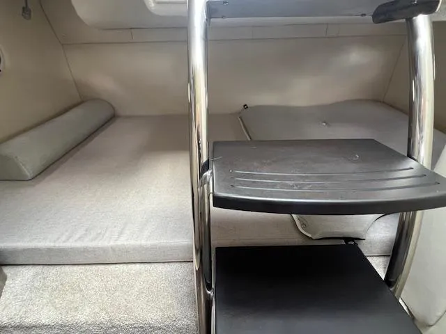 Slide: The Image of Interior cabin of 2019 Regal 26 Express boat with ladder and sleeping area. - 16