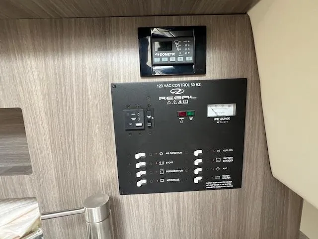 Slide: The Image of Control panel of a 2019 Regal 26 Express boat, featuring various switches and a display. - 17