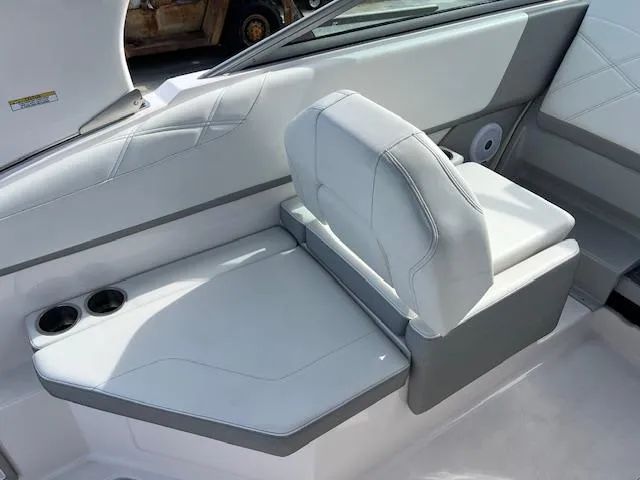 Slide: The Image of 2019 Regal 26 Express boat interior with white seating and cup holders. - 6