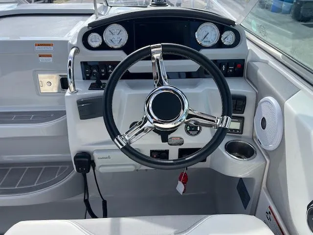 Slide: The Image of 2019 Regal 26 Express boat dashboard with steering wheel and gauges. - 9